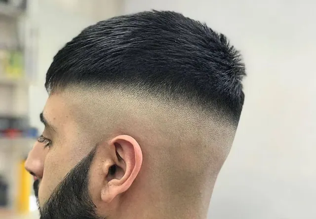 A crop with a high skin fade, close up
