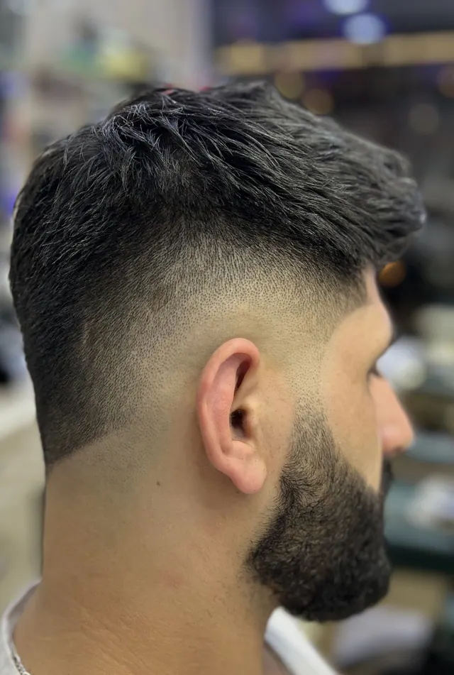 A textured cut with a fade into a full beard